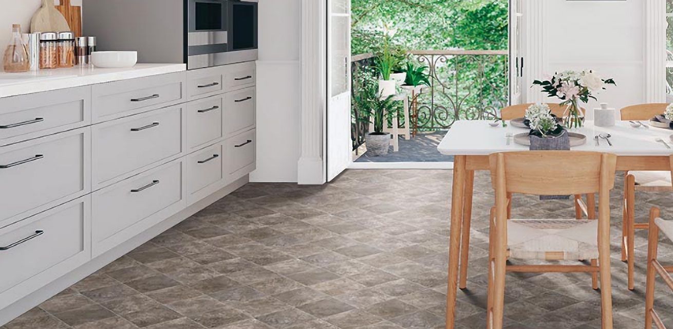 Warm grey Mohawk LVT floors add earthy balance to a sleek modern kitchen
